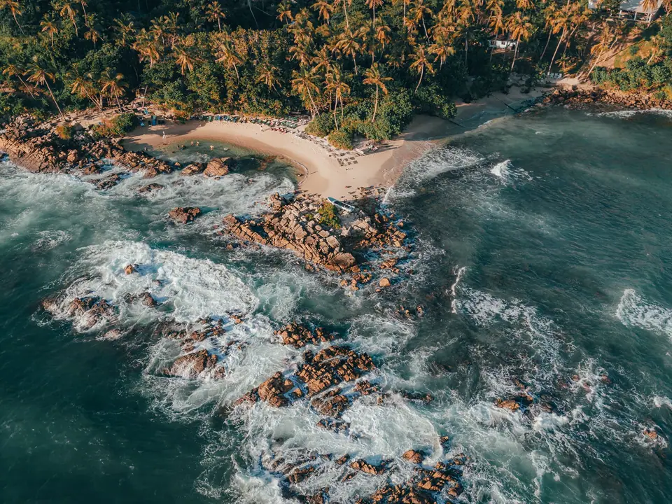 Aerial view of Mirissa bay and its palm-lined headland