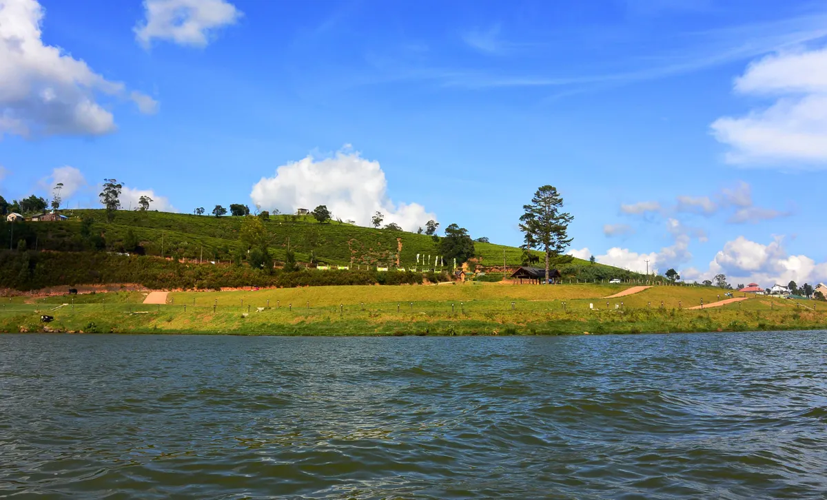 Pedal boats on Gregory Lake with the hills of Nuwara Eliya behind