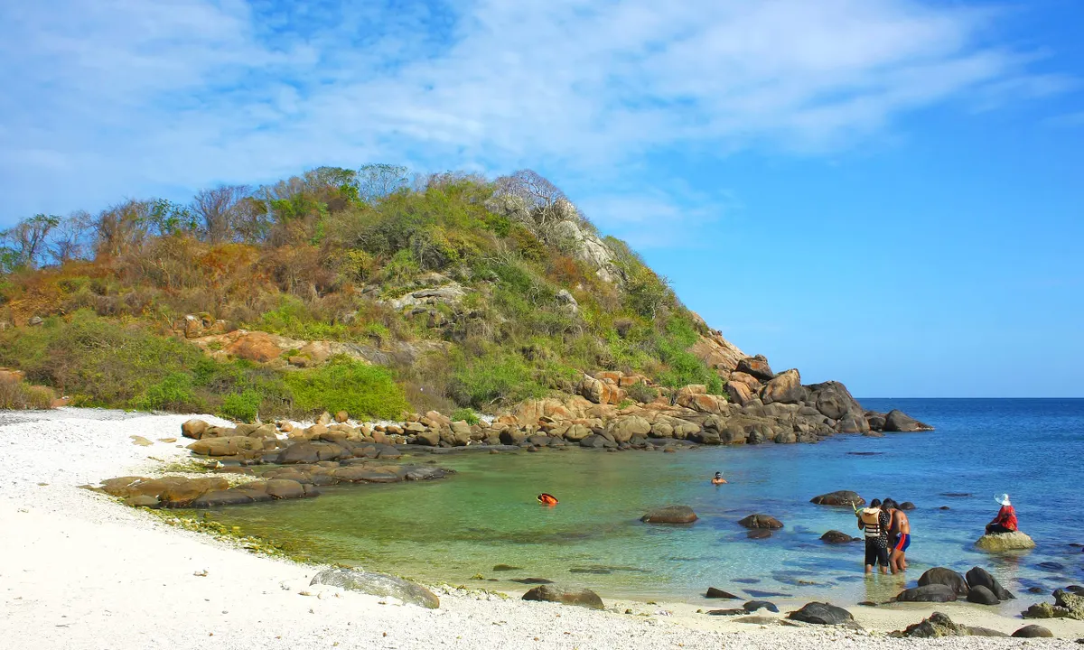 Snorkellers in the clear turquoise shallows off Pigeon Island near Nilaveli