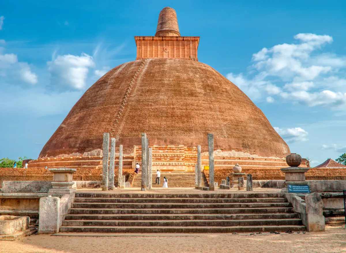 The vast brick dome of Jetavanaramaya stupa rising above the trees at Anuradhapura