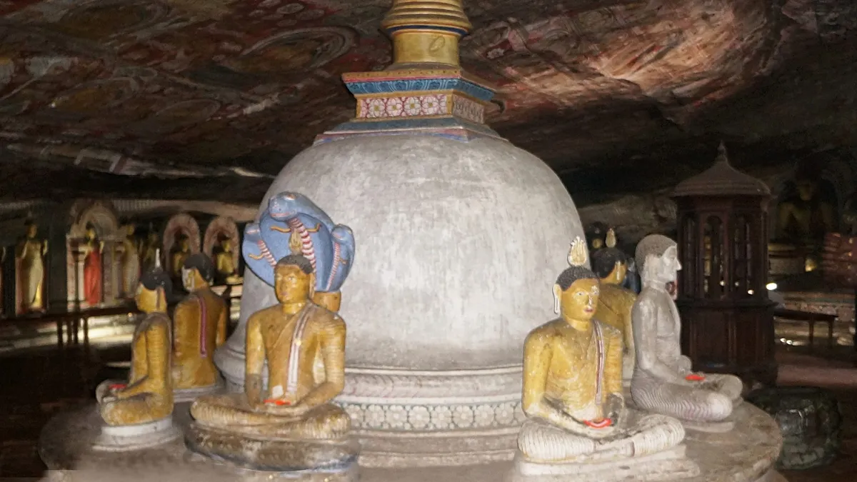 Buddha statues and a stupa inside the Dambulla cave temple