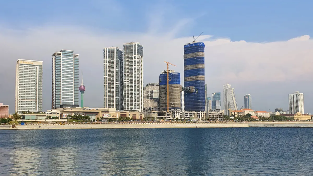 The Colombo skyline rising behind the Indian Ocean waterfront